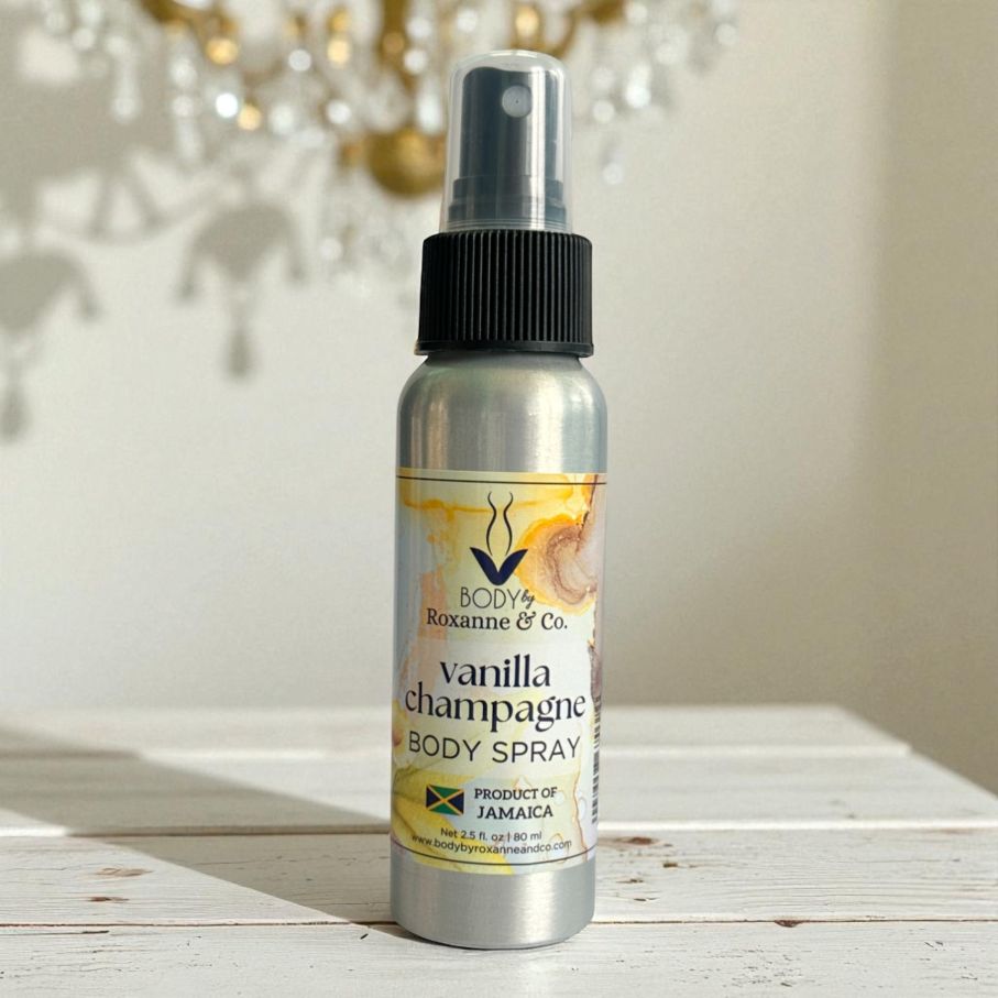 Vanilla champagne body spray bottle on a wooden surface with a blurred decorative background