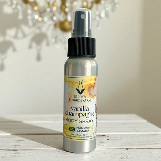 Vanilla champagne body spray bottle on a wooden surface with a blurred decorative background